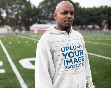 Full-Zip Hoodie Mockup Featuring a Man at a Football Field
