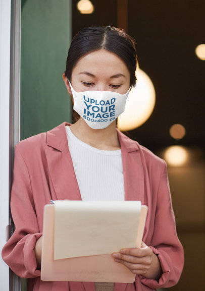 Face Mask Mockup of a Woman Taking Notes at a Work Meeting