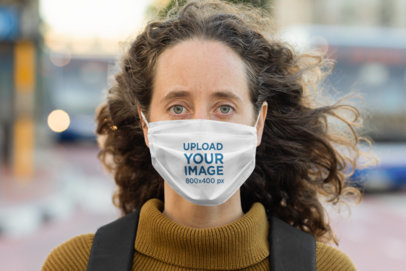 Face Mask Mockup of a Long-Haired Woman Standing on the Street