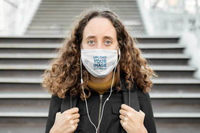 Face Mask Mockup Featuring a Curly-Haired Woman in an Urban Setting