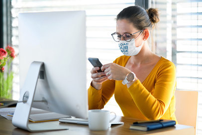 Face Mask Mockup Featuring a Woman Working on Her Desktop Computer