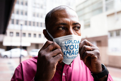 Mockup of a Serious Man Wearing a Face Mask on the Street