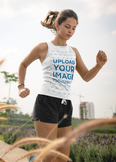 Tank Top Mockup of a Young Woman Running on a Natural Track 16851