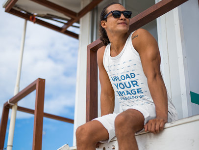 Mockup of a Lifeguard Wearing a Tank Top with Sunglasses at the Beach 12731