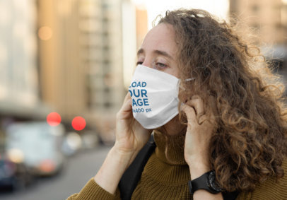Mockup of a Curly-Haired Woman Fixing Her Face Mask 