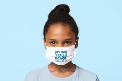 Sublimated Face Mask Mockup Featuring a Little Girl at a Studio