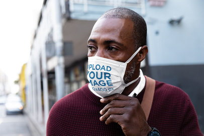Face Mask Mockup Featuring a Man Walking Down the Street