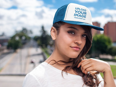 Hat Mockup of a Young Woman Walking Through a Pedestrian Bridge