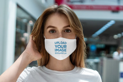 Mockup Featuring a Serious Young Woman Wearing a Sublimated Face Mask 