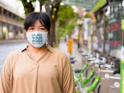 Mockup of a Serious Woman Wearing a Reusable Face Mask