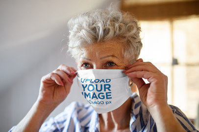 Mockup Featuring a Senior Woman Putting a Face Mask on 