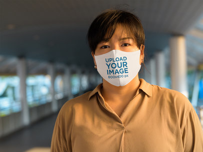 Reusable Face Mask Mockup Featuring a Serious Woman 