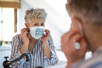 Face Mask Mockup of a Senior Woman Looking at the Mirror