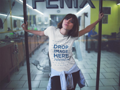 Young And Pretty Woman Holding From A Barbershop While Wearing A Round Neck T-Shirt At Night Mockup
