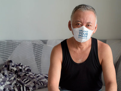 Face Mask Mockup Featuring a Man at Home