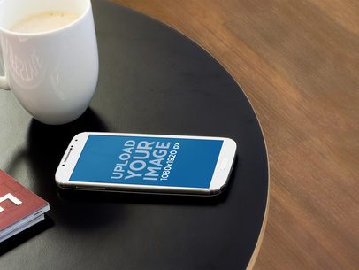 Mockup of a Samsung Galaxy Lying over a Round Table