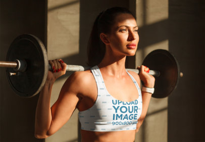 Sports Bra Mockup of a Strong Woman Lifting Weights