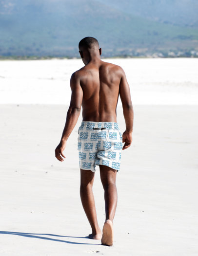 Mockup of a Man Walking on the Beach While Wearing Swimming Trunks