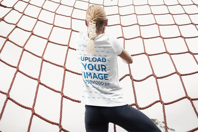 Back View Mockup Featuring a Woman Wearing a T-Shirt at a Military Training Camp