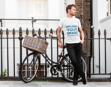 T-Shirt Mockup of a Man Posing with an Urban Bike