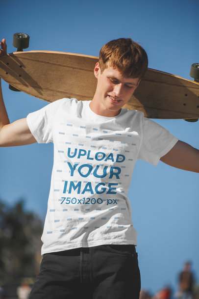 T-Shirt Mockup of a Young Man Holding His Board Up His Head