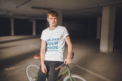T-Shirt Mockup of a Young Man Posing with His Bike with a Serious Look 35037-r-el2