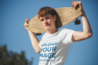 Round-Neck Tee Mockup of a Man Holding a Skateboard 