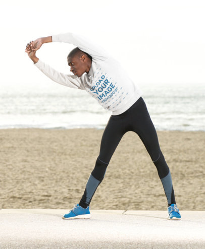 Sweatshirt Mockup of a Man Stretching by the Beach