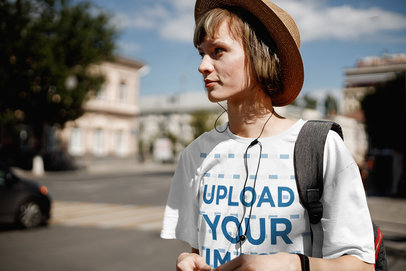 Mockup of a Woman with a Loose Tee Walking in a Foreign City