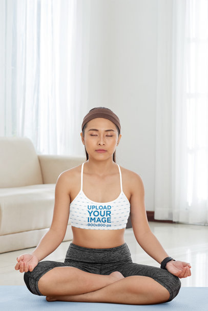 Mockup of a Woman Wearing a Sublimated Sports Bra While Meditating at Home
