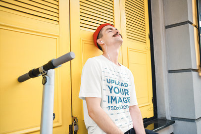 Mockup of a Man with a Loose T-Shirt Sitting Next to a Scooter 39877-r-el2