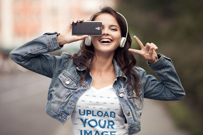 T-Shirt Mockup of a Young Woman Having Fun with Her Phone 38057-r-el2