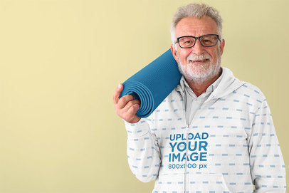 Full-Zip Hoodie Mockup of a Senior Man Ready for Yoga Class 