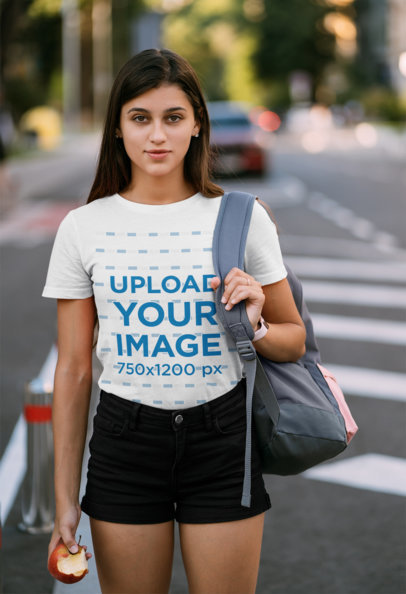 T-Shirt Mockup of a Woman on the Street Holding an Apple