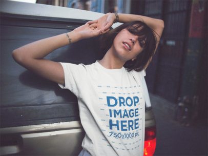Trendy Woman Wearing A Round Neck Tee In The City While Lying Against An SUV Mockup
