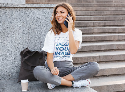 T-Shirt Mockup of a Woman Sitting on the Floor and Talking on the Phone