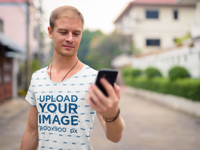 Sublimated T-Shirt Mockup Featuring a Man Looking at His Phone 40333-r-el2