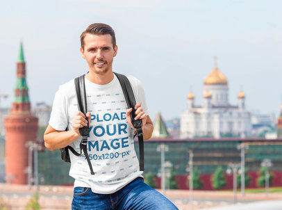 T-Shirt Mockup of a Tourist Man Backpacking in a City 