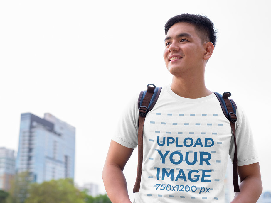 T-Shirt Mockup Featuring a Young Man in the City