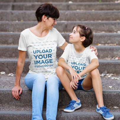 T-Shirt Mockup of a Woman and Her Daughter Sitting on Concrete Stairs