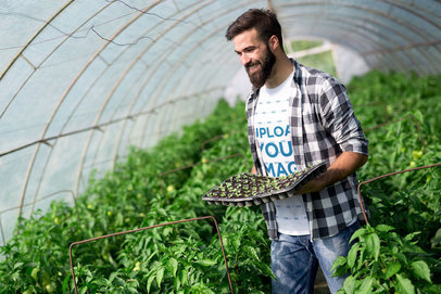 T-Shirt Mockup Featuring a Man in a Greenhouse