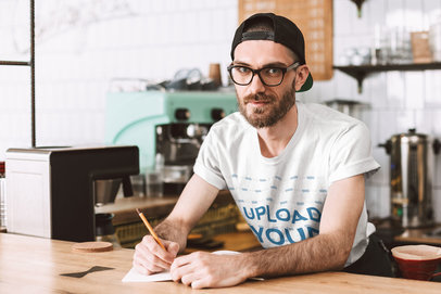 T-Shirt Mockup of a Hipster Barista Behind a Bar