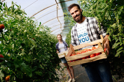 T-Shirt Mockup of a Man Holding a Box of Tomatoes 