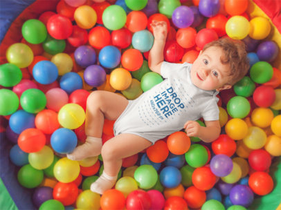 Pretty Baby Boy Having Fun At A Ball Pit Wearing A Onesie MockupPretty Baby Boy Having Fun at a Ball Pit Wearing a Onesie Mockup