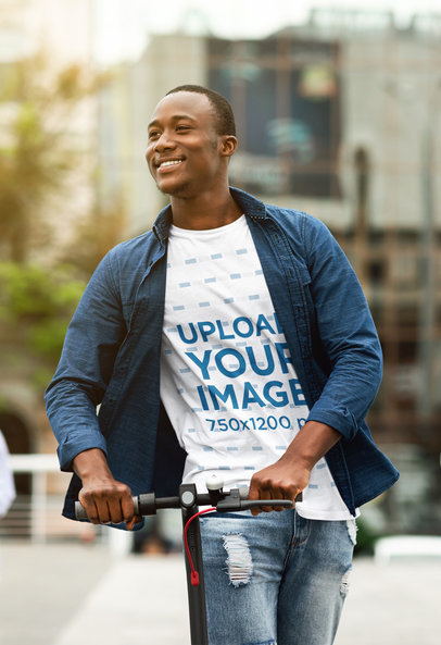 T-Shirt Mockup of a Smiling Man Riding a Scooter in the City 