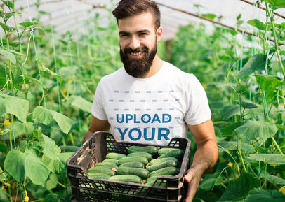 T-Shirt Mockup Featuring a Man Carrying a Box of Cucumbers 