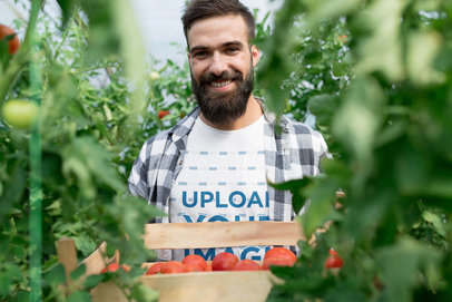 Tee Mockup of a Joyful Farmer Carrying a Tomato Box 