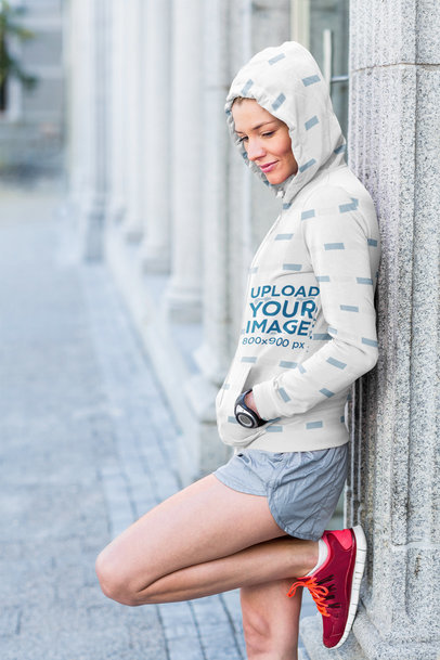 Full-Zip Hoodie Mockup Featuring a Woman Leaning Against a Street Column