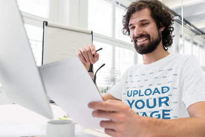 T-Shirt Mockup of a Happy Man Reviewing Some Papers 40702-r-el2