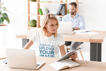 T-Shirt Mockup of a Woman Working in an Office